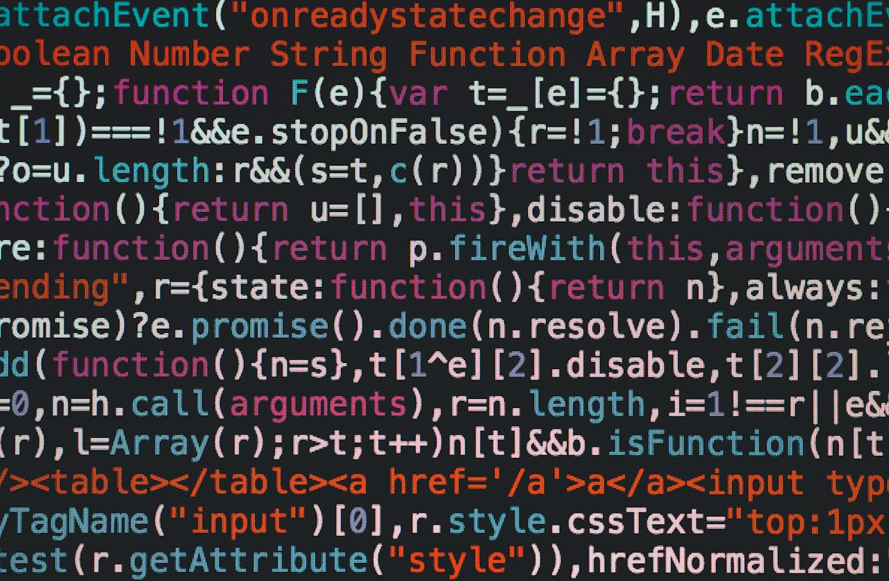 who-we-are Close-up of colorful coding text on a dark computer screen, representing software development.